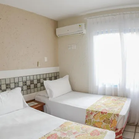 Costao Do Santinho Resort All Inclusive Florianópolis Habitación foto This is a bright and clean photo of a hotel or guest room with two twin beds.

The room has light-colored walls, and above the beds, there is a decorative tiled accent wall featuring a geometric pattern in shades of gray and white. A white air condit